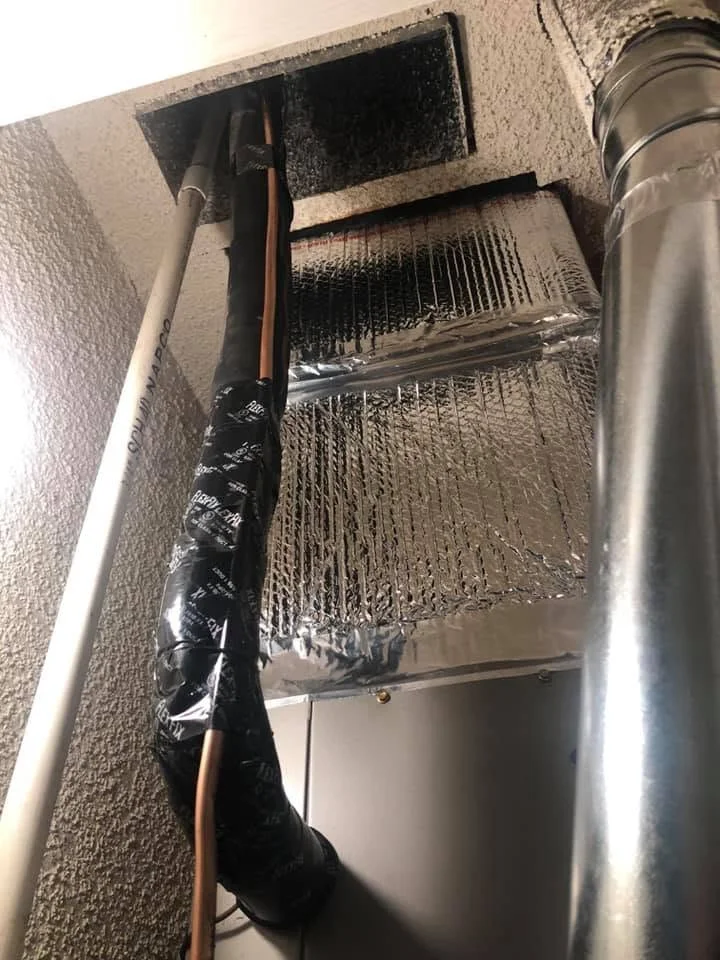 Air duct cleaning with wrapped insulation and debris removal from HVAC system
