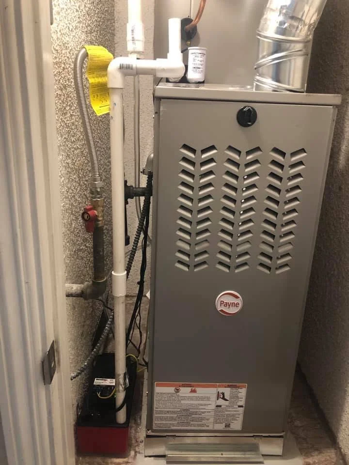 Payne gas furnace installation with PVC venting, copper gas line, and condensate drain in utility closet