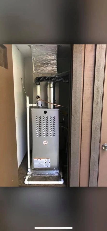 Installed furnace with insulated ductwork, piping, and roof venting in mechanical closet