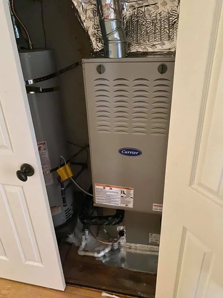 Carrier gas furnace installation with ductwork, venting, and condensate lines in mechanical closet