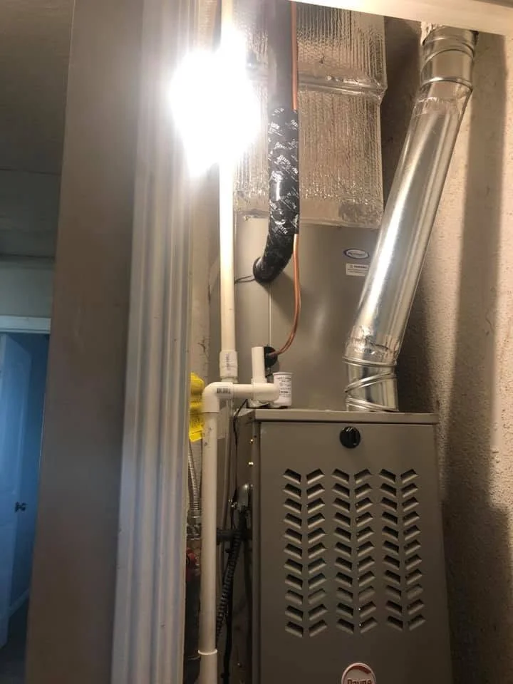 New furnace unit with metal ductwork and insulation in mechanical closet